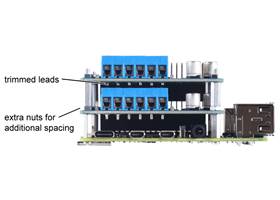 Two Motoron M2H boards with terminal blocks can be stacked if you trim the leads on the terminal blocks and space out each board using hex nuts in addition to the 11mm standoffs.