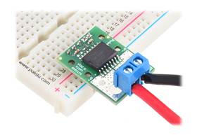 CT432/CT433 TMR Current Sensor Compact Carrier with a 5mm-pitch terminal block for the current path and header pins soldered for use with a breadboard.